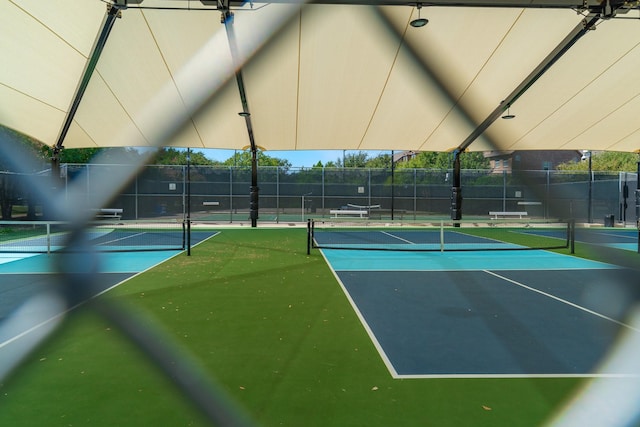 view of tennis court featuring fence