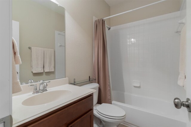 full bathroom featuring vanity, shower / bath combo with shower curtain, and toilet