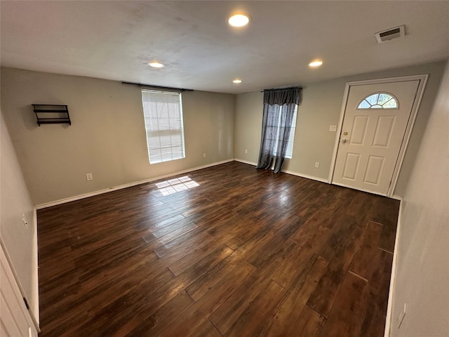 entryway with dark wood-style floors, recessed lighting, visible vents, and baseboards