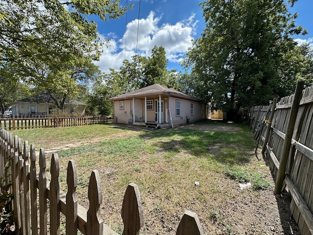 view of yard with entry steps and a fenced backyard