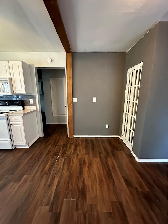 kitchen with white appliances, dark wood-type flooring, backsplash, and white cabinets