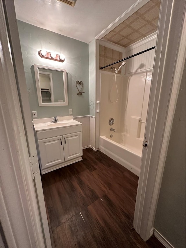 full bath featuring shower / bathtub combination, wood finished floors, and vanity