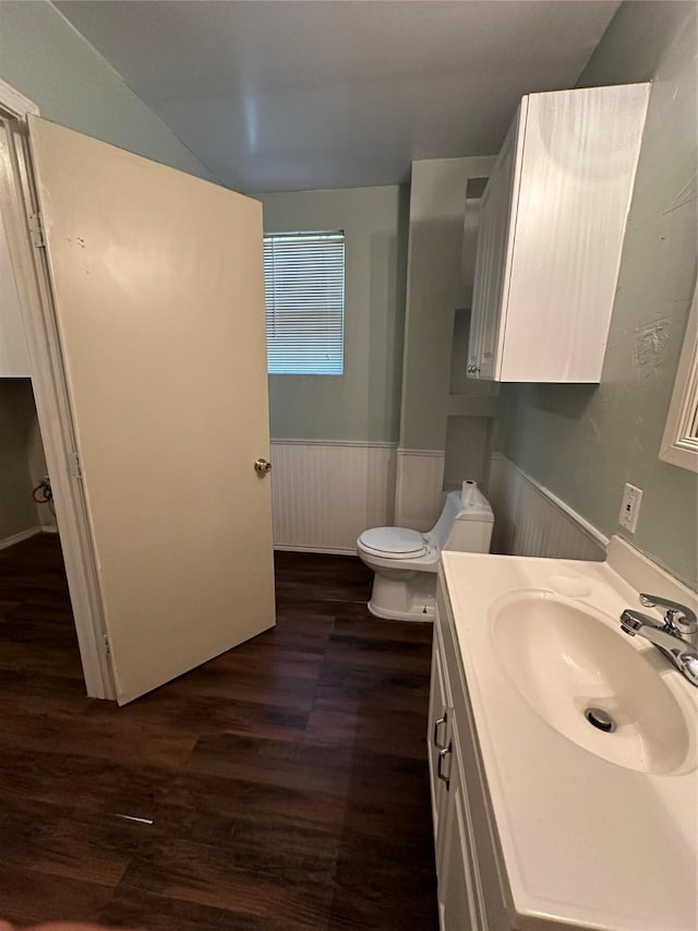 bathroom featuring wainscoting, vanity, toilet, and wood finished floors