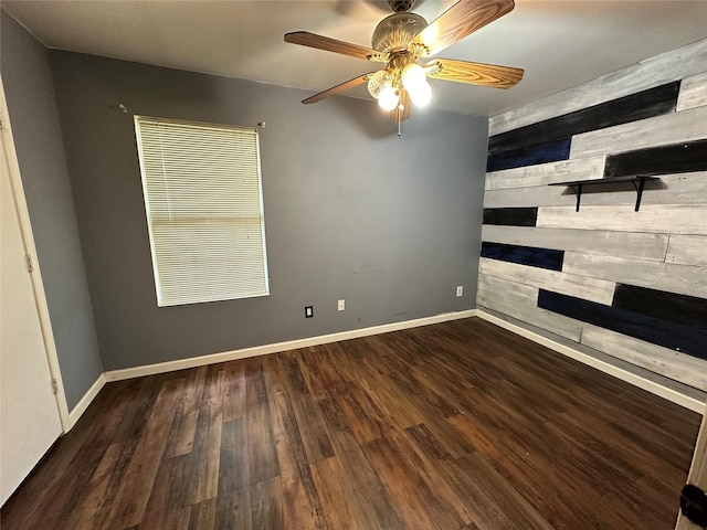 interior space featuring ceiling fan, baseboards, and wood finished floors