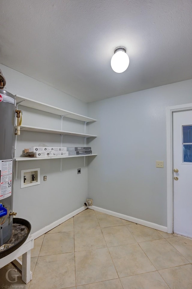 clothes washing area featuring light tile patterned floors, hookup for a washing machine, laundry area, baseboards, and electric dryer hookup