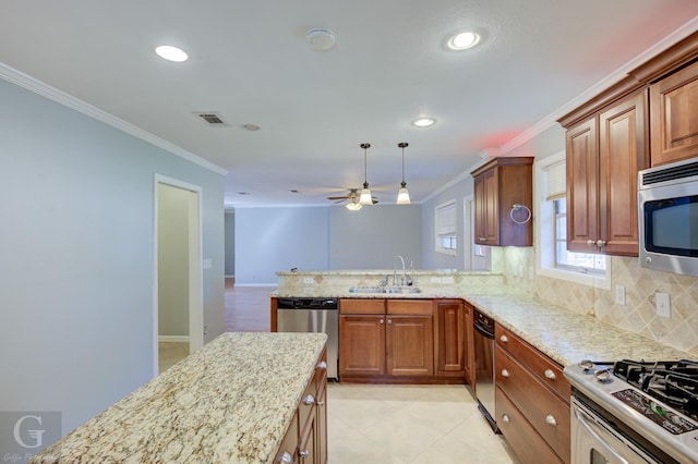 kitchen with visible vents, appliances with stainless steel finishes, ornamental molding, light stone countertops, and a sink