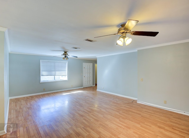 empty room with light wood-style floors, visible vents, ornamental molding, and baseboards