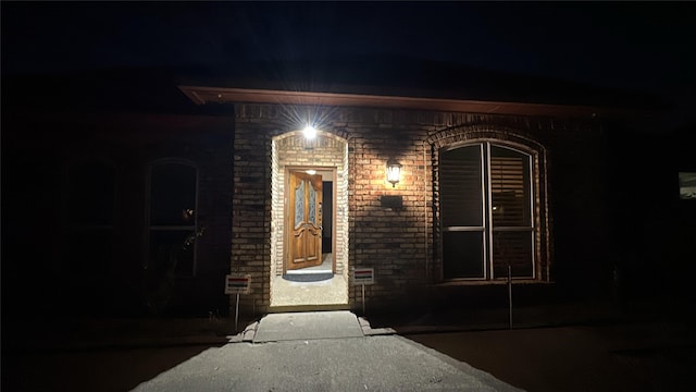 exterior entry at twilight with brick siding