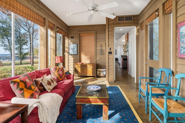 sunroom featuring ceiling fan, visible vents, and a healthy amount of sunlight