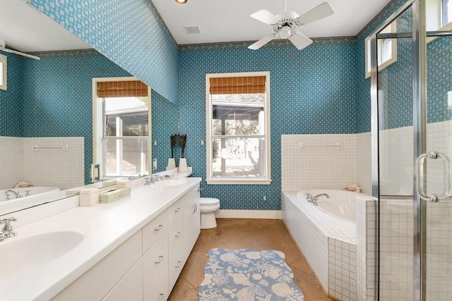 full bath featuring wallpapered walls, toilet, a sink, baseboards, and a bath