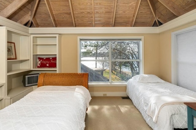 bedroom featuring lofted ceiling with beams, wooden ceiling, and carpet flooring