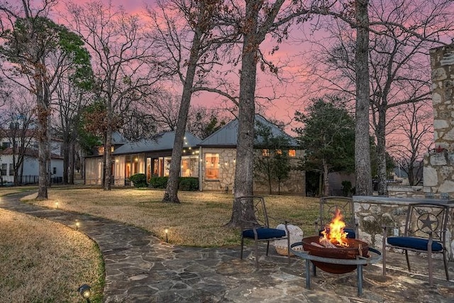 exterior space with an outdoor fire pit and a patio area