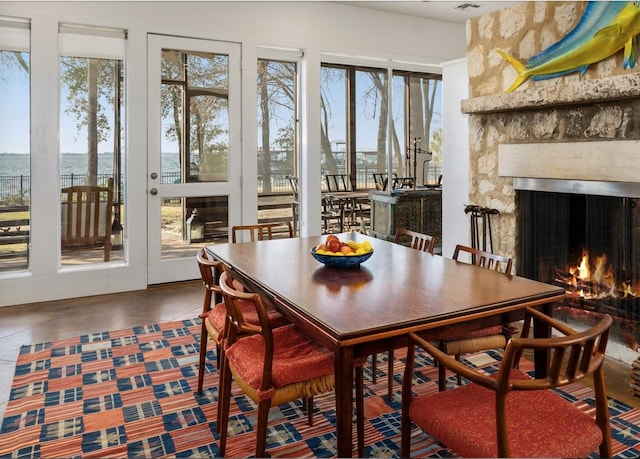 dining area featuring visible vents and a fireplace