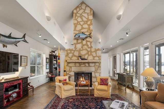 living room with visible vents, a fireplace, baseboards, and tile patterned floors