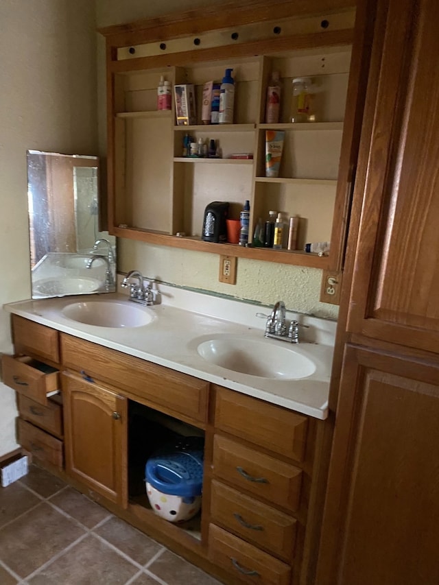 bathroom featuring double vanity, tile patterned flooring, and a sink
