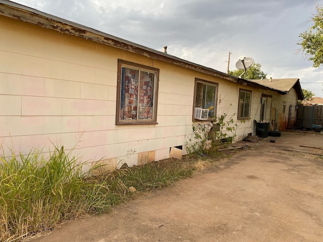 view of property exterior with crawl space and cooling unit