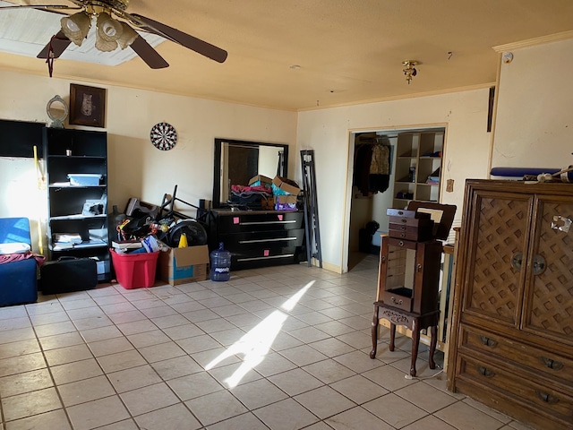 living area featuring light tile patterned floors and a ceiling fan