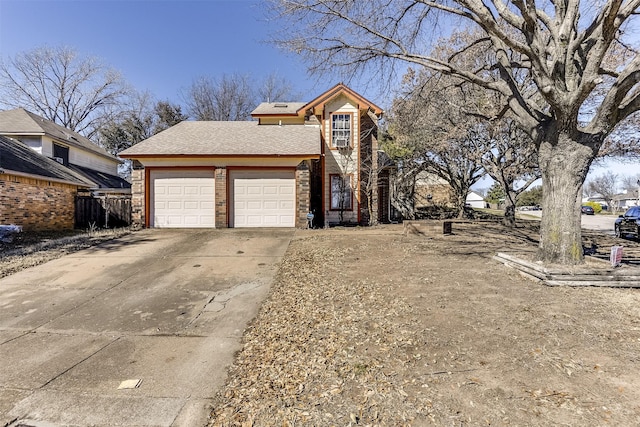 view of front of property with a garage, concrete driveway, and a shingled roof