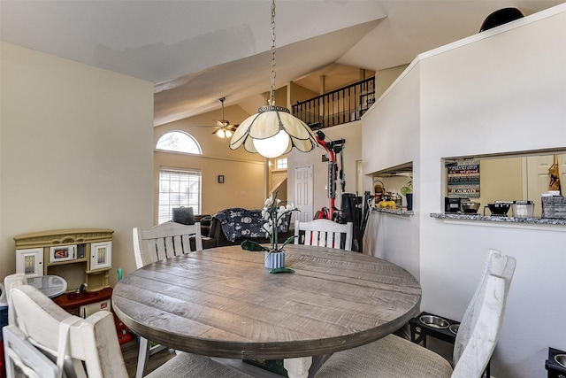 dining space featuring high vaulted ceiling and a ceiling fan