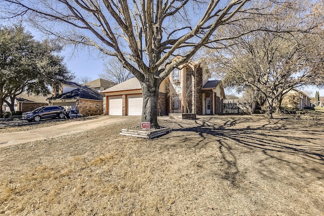 obstructed view of property featuring a garage, driveway, and brick siding