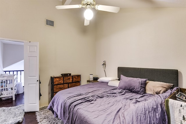 bedroom with visible vents, dark wood finished floors, and a ceiling fan