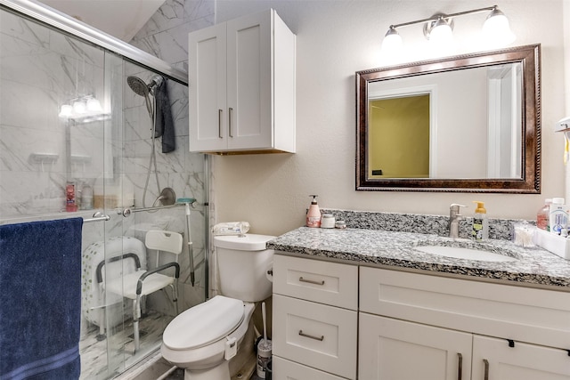 full bathroom featuring toilet, a shower stall, and vanity