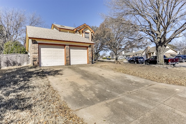 view of side of property with driveway, brick siding, and roof with shingles