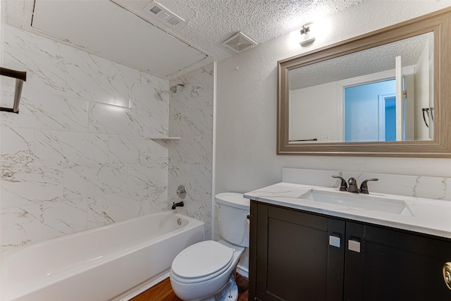 bathroom with visible vents, a textured ceiling, toilet, and vanity