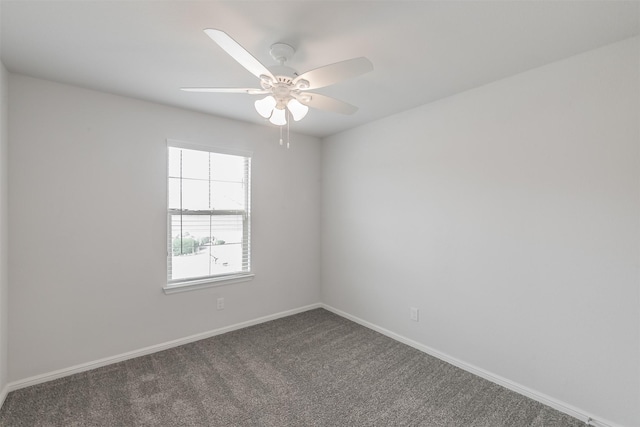 spare room featuring a ceiling fan, carpet flooring, and baseboards