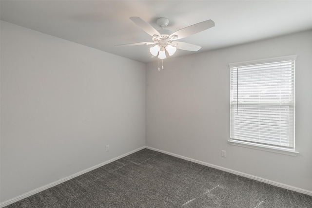 empty room with dark carpet, baseboards, and ceiling fan