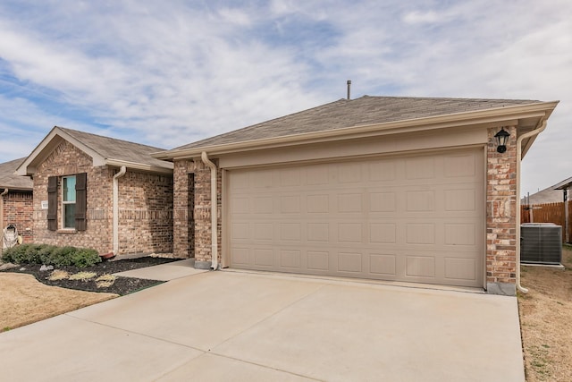 ranch-style home with a garage, driveway, a shingled roof, and brick siding