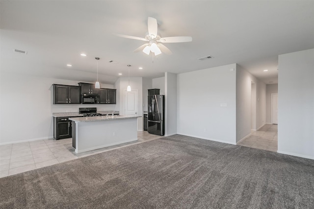 kitchen featuring gas range, black microwave, stainless steel refrigerator with ice dispenser, and light colored carpet