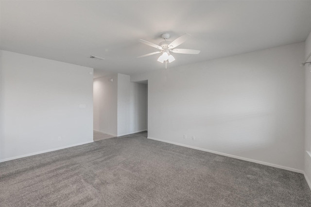 carpeted spare room featuring ceiling fan, visible vents, and baseboards