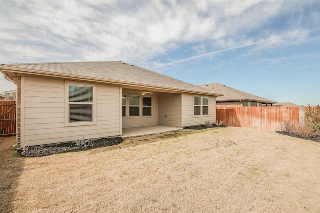 rear view of property featuring a yard, a patio area, a fenced backyard, and a ceiling fan