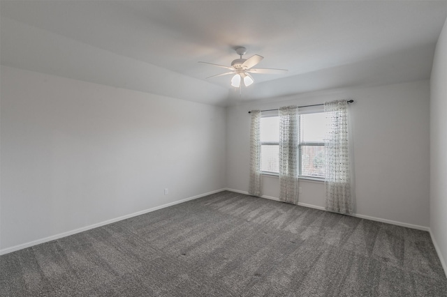 empty room with carpet floors, a ceiling fan, and baseboards