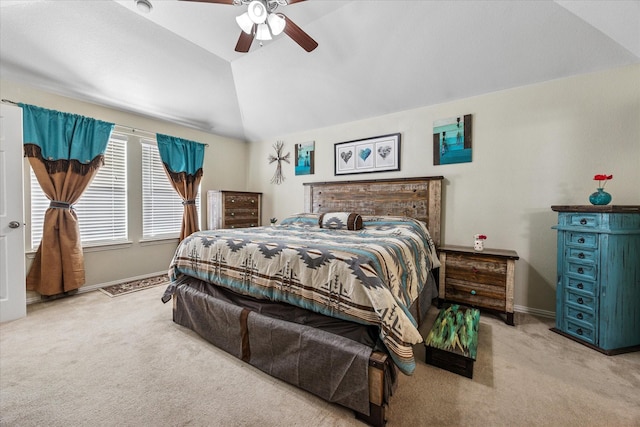 carpeted bedroom with baseboards, vaulted ceiling, and a ceiling fan