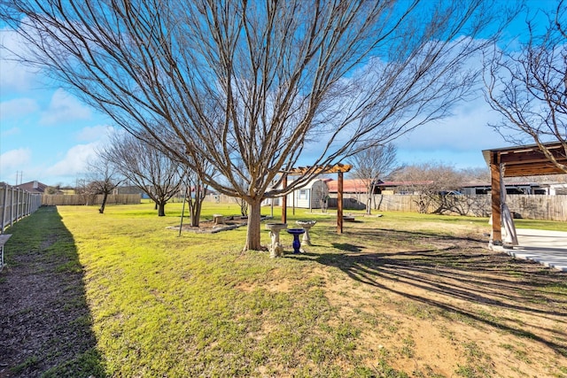 view of yard featuring a fenced backyard and an outdoor structure