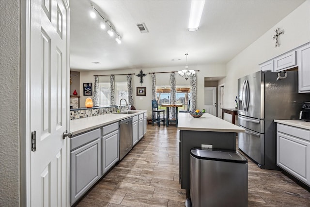 kitchen with visible vents, appliances with stainless steel finishes, light countertops, and a sink