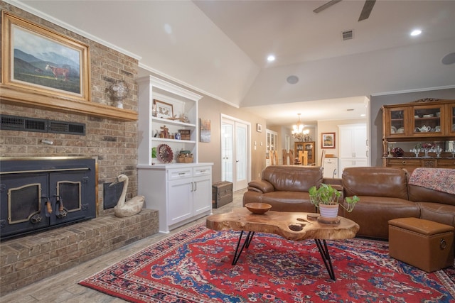 living area with wood finished floors, ceiling fan with notable chandelier, vaulted ceiling, a fireplace, and recessed lighting