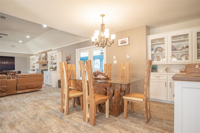 dining room with recessed lighting, visible vents, lofted ceiling, light wood-type flooring, and ceiling fan with notable chandelier