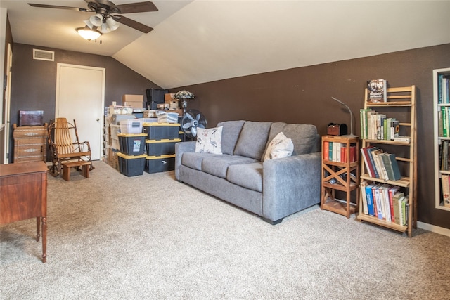 carpeted living area featuring lofted ceiling, visible vents, and ceiling fan