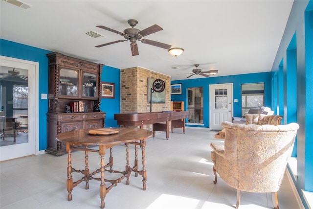 dining room with light floors, ceiling fan, and visible vents