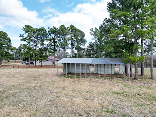 view of front of house with an outbuilding and a front lawn