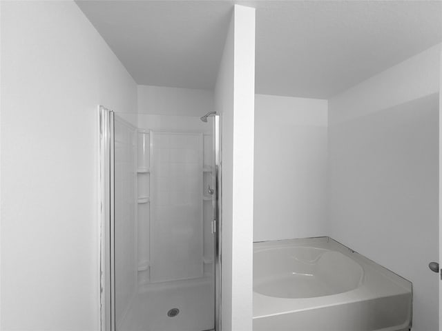 full bath featuring a shower stall and a bath