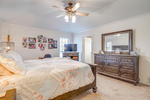 bedroom featuring light carpet, crown molding, visible vents, and ceiling fan