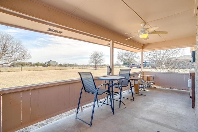 sunroom / solarium featuring ceiling fan