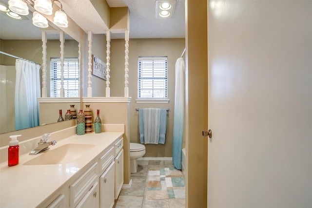 full bathroom with baseboards, vanity, and toilet