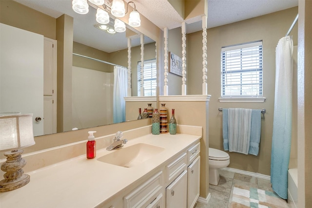 bathroom featuring toilet, a shower with curtain, a wealth of natural light, and vanity