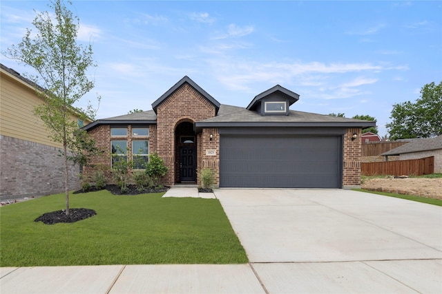 1825 Osage Trl, Mesquite, TX 75149 - view of front of property featuring brick siding, an attached garage, and driveway