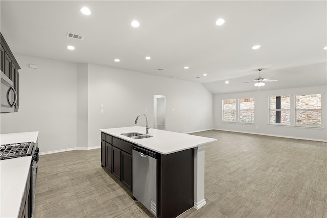 1825 Osage Trl, Mesquite, TX 75149 - kitchen featuring stainless steel appliances, ceiling fan, a sink, light countertops, and a kitchen island with sink